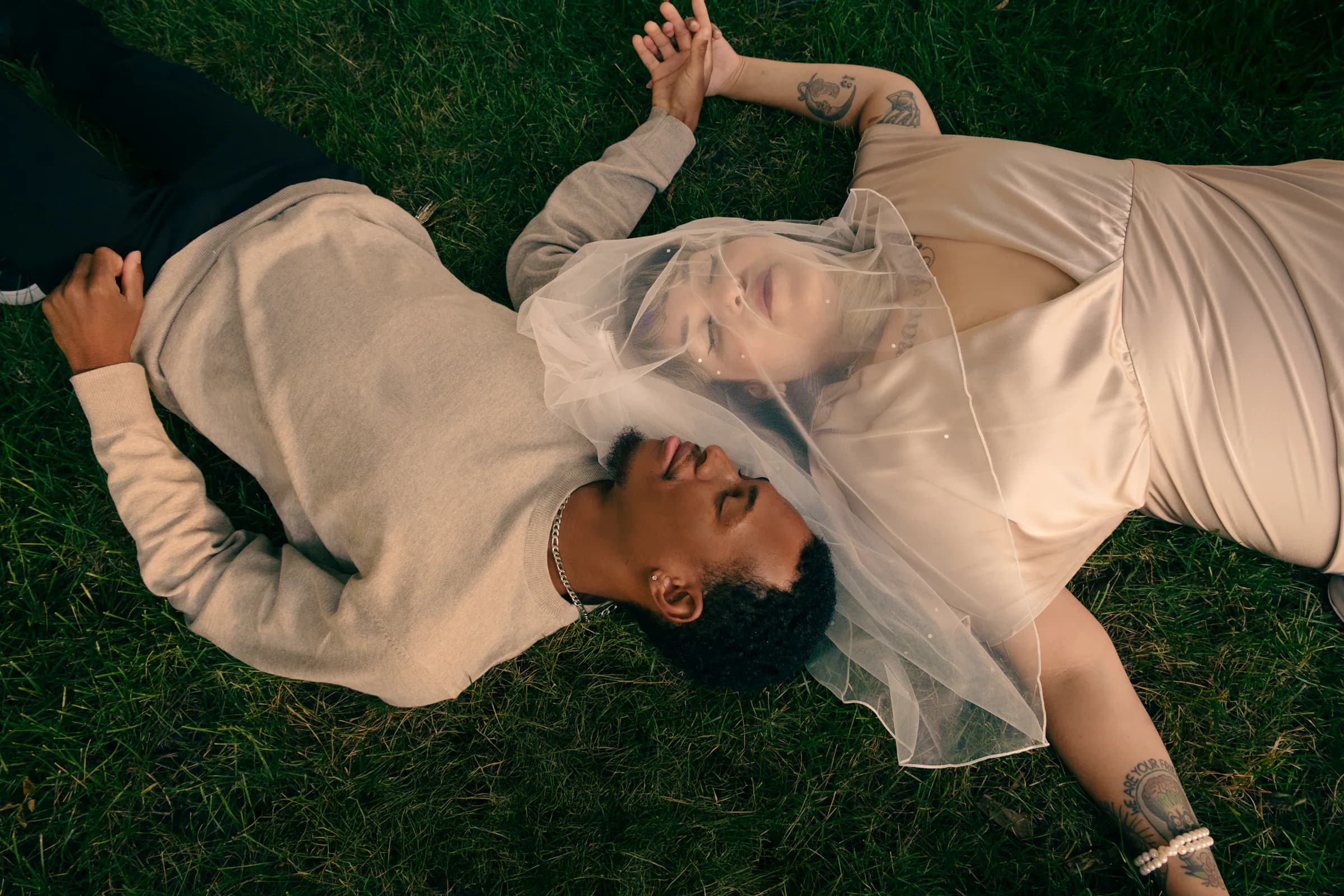 Couple resting together on the grass
